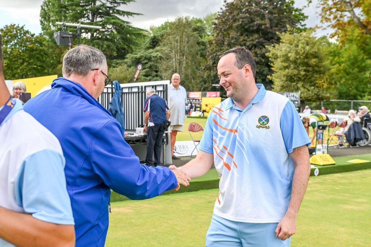 Elliott Winskill shaking hands on the green at the 2025 Aviva National Bowls Finals
